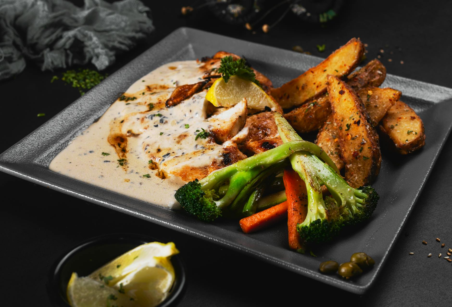 Kurczak w sosie śmietanowym z musztardą – szybki obiad bez wysiłku Pieczony kurczak z sosem śmietanowym, ziemniakami i warzywami na talerzu