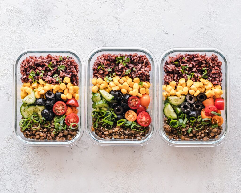 Kolorowy meal prep z kukurydzą, oliwkami, pomidorami i soczewicą